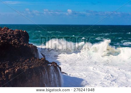 Sea Waves Hitting Rocks Cliff At Praia Da Bordeira, Portugal