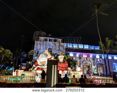 Honolulu - December 18, 2017: People Look At Mr. And Mrs. Claus Sit On Top Waterfall With Turtle Fig