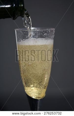 Champagne. Pouring Champagne into a glass. Glass of Champagne.