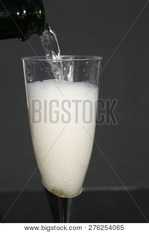 Champagne. Pouring Champagne into a glass. Glass of Champagne.
