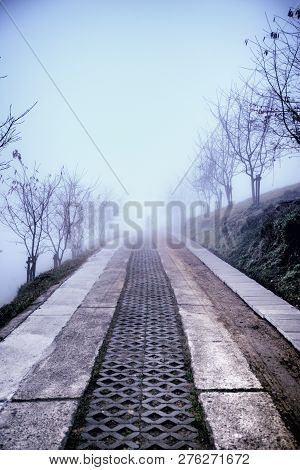 Taiwan, Cingjing - January 2013: A Straight Path Into The Unknown. From Far, One Can See A Couple Wa