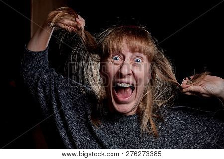 Woman With Hair Curlers And With Funny Emotion On The Face. Anger, Resentment, Pain. Girl Dont Like 