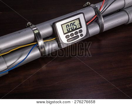 Pipe Bomb With An Lcd Clock Timer To Trigger Detonation, On Wooden Table