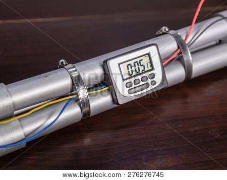 Pipe Bomb With An Clock Timer To Trigger Detonation, On Wooden Table