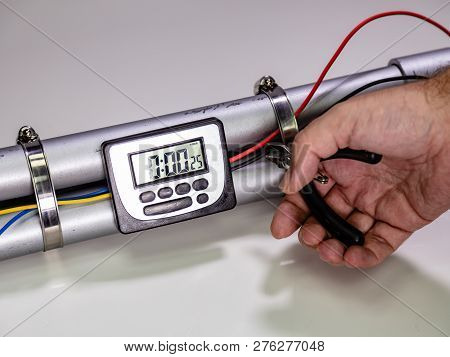 Hand Cutting Wire On Pipe Bomb On White Background
