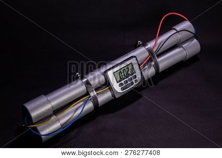 Pipe Bomb With An Clock Timer To Trigger Detonation On Black Background