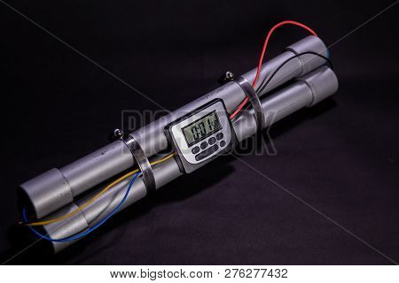 Pipe Bomb With An Clock Timer To Trigger Detonation On Black Background