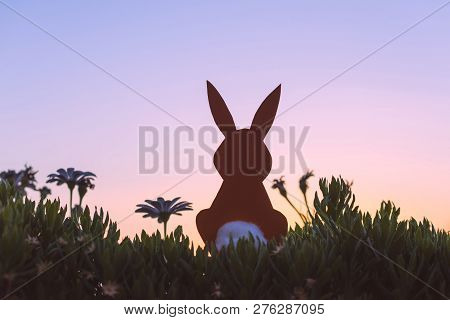 Creative Easter Photo Of Silhouette  Paper Rabbit In The Chamomile Flowers And Green Grass On The Su