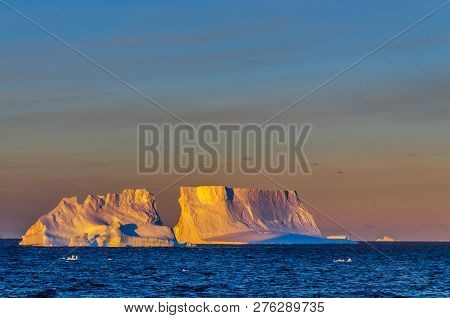 Antarctic Sunset: Floating Icebergs In The Weddell Sea, Near The Antarctic Peninsula, As Seen From A