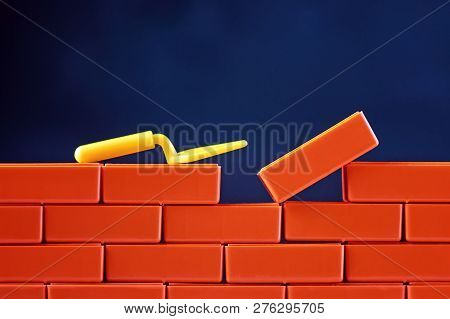 Finishing Task Concept. Brickwork And Building Trowel On Dark Background