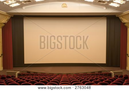 Empty Modern Cinema Auditorium With White Screen