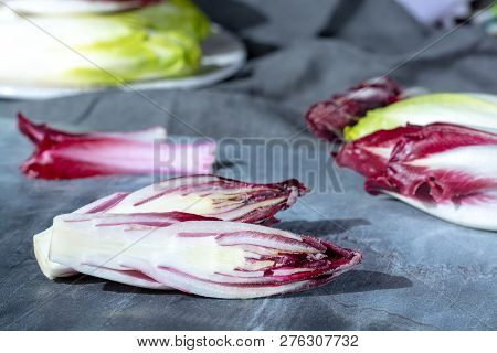 Group Of Fresh Green Belgian Endive Or Chicory And Red Radicchio Vegetables, Also Known As Witlof Sa