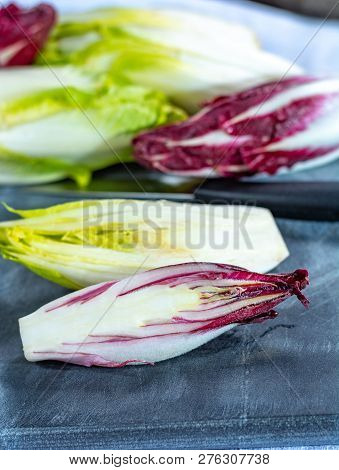 Group Of Fresh Green Belgian Endive Or Chicory And Red Radicchio Vegetables, Also Known As Witlof Sa
