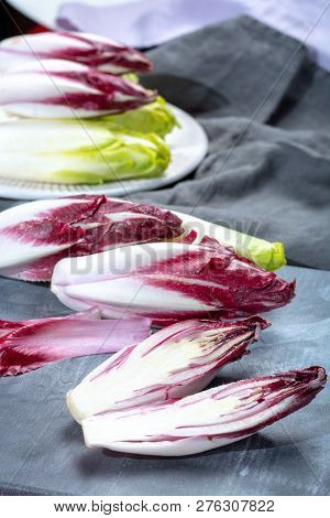 Group Of Fresh Green Belgian Endive Or Chicory And Red Radicchio Vegetables, Also Known As Witlof Sa