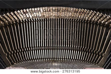 The image shows a detailed picture of type lever from a typewriter