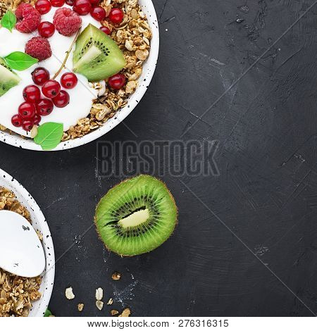 Breakfast Super Bowl Homemade Baked Granola With Yoghurt, Kiwi Slices, Currant, Mint, Basil And Fres