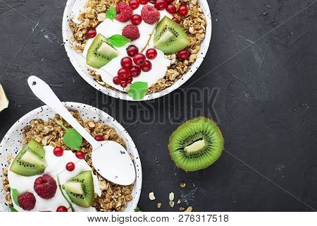Breakfast Super Bowl Homemade Baked Granola With Yoghurt, Kiwi Slices, Currant, Mint, Basil And Fres