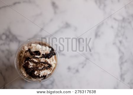 Chocolate Sauce And Whipped Cream On Top Iced Drink With Marble Background