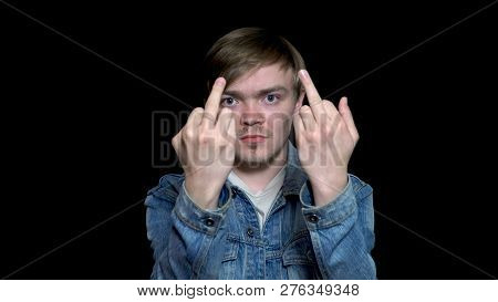 Man In Blue Jean Jacket Is Showing Fuck Off Sign With The Middle Finger, Isolated On Black Backgroun