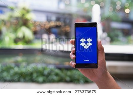 Chiang Mai, Thailand - May 05,2018: Man Hands Holding Huawei With Dropbox On Screen. Dropbox Is A Se