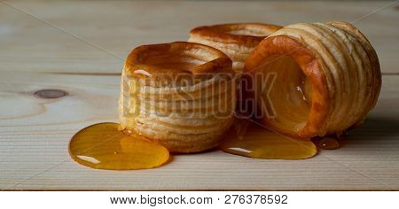 Dough Barrels With Honey On Wooden Background.