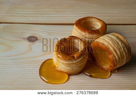 Dough Barrels With Honey On Wooden Background.
