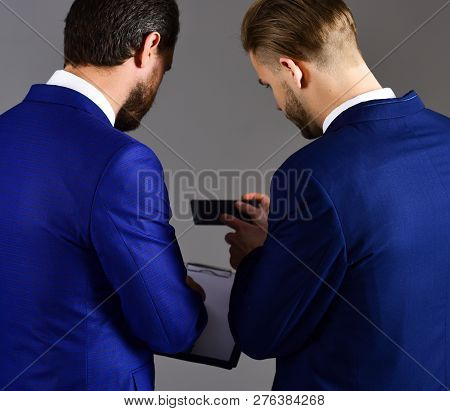 Businessmen Or Spy Looks At Secret Document. Information Leak Concept. Men In Suit Or Businessmen Ho