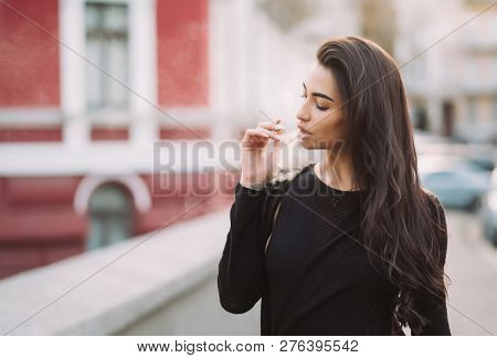 Sexy, Young Woman In The Body Smokes In The Street