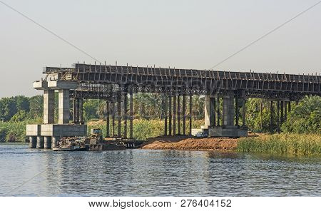 View Of Large Concrete Road Bridge Under Construction Spanning Wide Nile River In Egypt At Kom Ombo