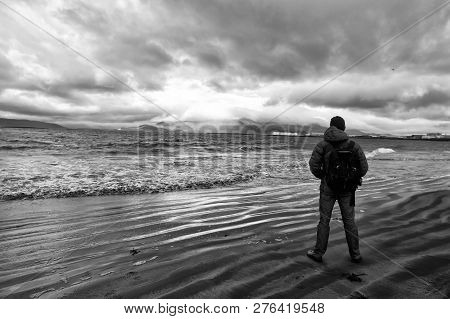 Man Looks On Horizon With Reykjavik Seascape In Iceland. Future Goals Concept. Nature Lovers. Travel