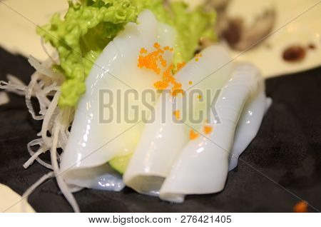 Traditional Japanese Food Ika (squid) Sashimi On Wooden Table