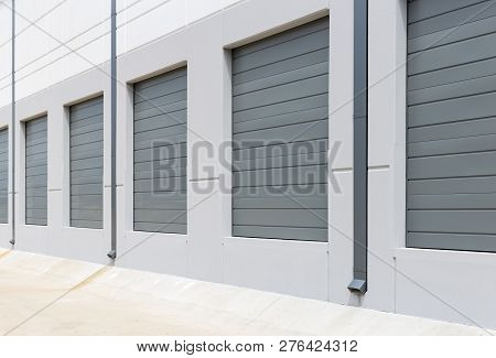 Empty warehouse loading dock white walls gray metal sliding doors