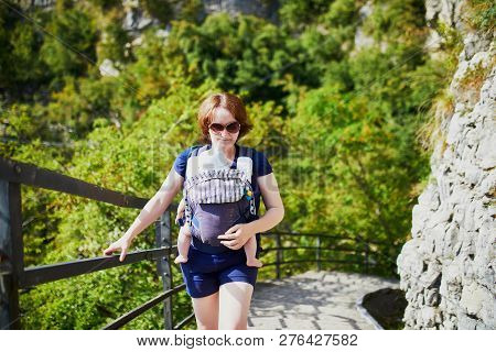 Woman With Little Girl In Carrier Enjoying Hiking In Gandria Village Near Lugano, Canton Of Ticino, 