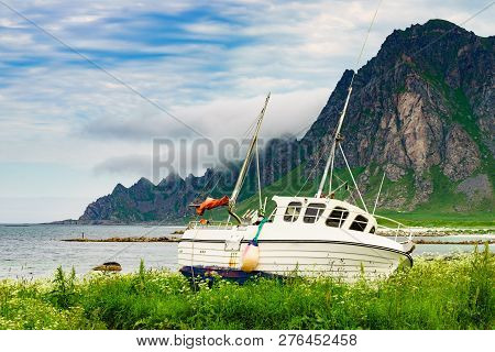 Seascape With Old Fishing Boat On Seashore And Mountains In The Background. Bleik Village, Andoya Is