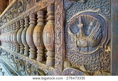 Ava, Myanmar - February 21, 2018: The Close-up Of The Wooden Handrail In Bagaya Monastery With Compl