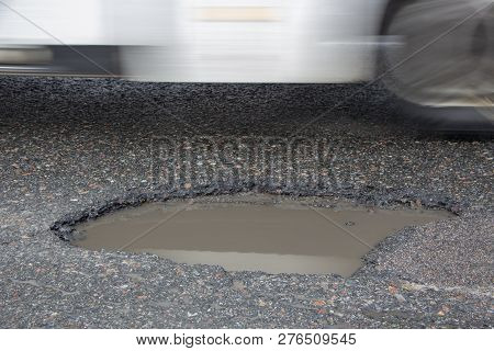 There Are Many Potholes On The Roadway Close Up