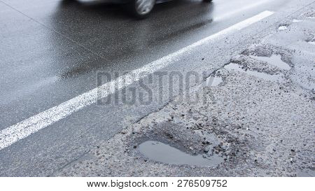 There Are Many Potholes On The Roadway Close Up