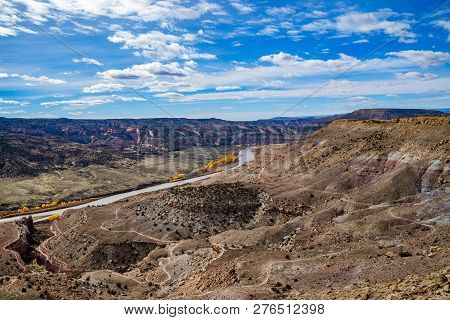 View From Summit Of Mcinnis Canyons In Utah With Blue Sky And Clouds.