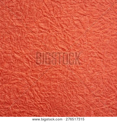 rusty red Japanese Momi Washi paper background featuring a rough, evenly textured surface formed by crinkling the paper during the manufacturing process