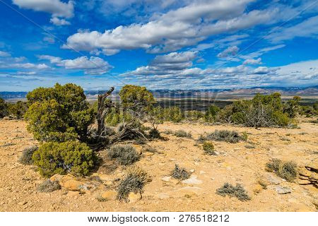 View From Summit Of Mcinnis Canyons In Utah With Blue Sky And Clouds.