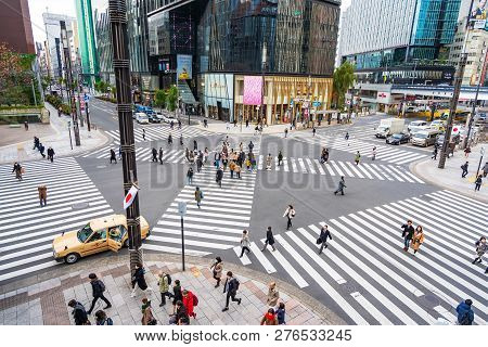 Ginza, Tokyo, Japan - December 27, 2018: Crowd Pedestrians People Walking On Zebra Crosswalk At Ginz