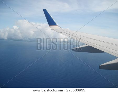Left Air Plane Wing Flying Over The Coast Of Guam
