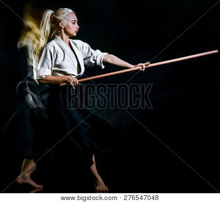 Bo-Jutsu bodoka woman isolated black background