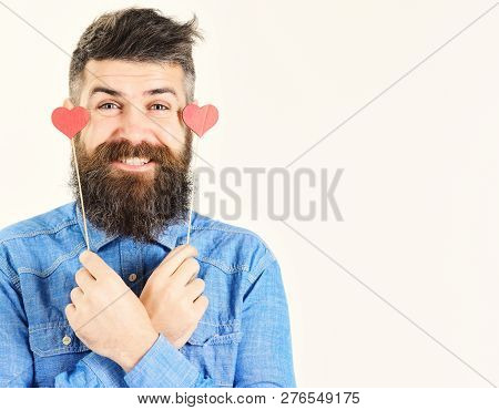 Bearded Serious Man In Blue Shirt Holds Small Hearts Valentines. Handsome Smiling Guy Isolated On Wh
