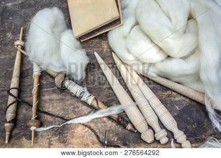 Primitive Spindles And White Sheep's Wool