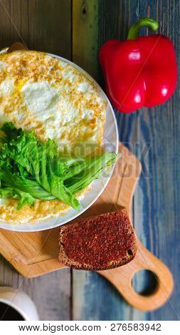Fried Egg In The Form Of A Pancake, Wooden Cutting Board. Breakfast, Still Life.