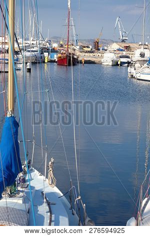 Tight Marine Yacht Parking In Calm Water On Bright Summer Day With Mountains Af Far