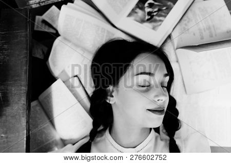 Girl With Pigtails In White Blouse At Old Library.