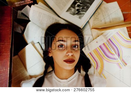 Girl With Pigtails In White Blouse At Old Library.