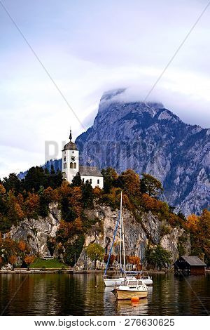 Beautiful Scenic Sunset Over Austrian Alps Lake. Boats, Yachts In The Sunlight Infront Of Church On 